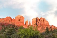 the red rocks are towering over the trees