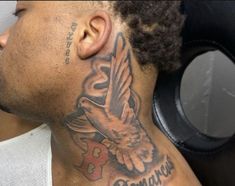 a man with a bird tattoo on his neck