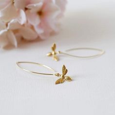 These are lovely bee earrings. Cute little gold bees hang from gold plated long oval hook ear wires. Simple yet adorable, these earrings are great accessories for spring and summer, and would make a wonderful gift for a bee lover :) The bees are made of brass, and measure 13mm.  Total length of these earrings is approx. 2" (54mm). More bee jewelry designs are available in my shop. Some are as seen in the last picture. Thank you for stopping by. Please contact me if you have any questions or need a different quantity :) Custom orders are welcome. ♥ Click the link below to see more beautiful modern earrings: www.etsy.com/shop/LeChaim?section_id=17655958 My shop: http://www.etsy.com/shop/LeChaim About LeChaim: http://www.etsy.com/shop/LeChaim/about an Original and Handmade design of Melanie K Earrings Bee, Bee Jewelry, Gold Bee, Bee Earrings, Long Dangle Earrings, Modern Earrings, Handmade Design, Jewelry Designs, Earrings Gold