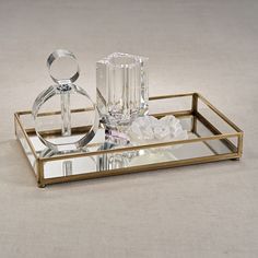 a glass and metal tray with two rings on it