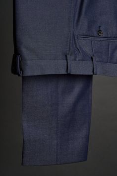 A handmade bespoke trouser crafted from an exceptional English wool denim fabric. With a substantial weight of 370g/12oz, this fabric offers a luxurious drape and exceptional durability. These trousers blend the classic appeal and functionality of denim, with the warmth, comfort and sophistication of wool. These will be your new favorite pants - and you can wear them with everything. Luxury Straight Leg Dress Pants For Semi-formal Occasions, Fitted Denim Pants With Welt Pockets, Elegant Denim Blue Bottoms With Pockets, Classic Denim Blue Wide Leg Pants, Fitted Indigo Wide Leg Pants, Indigo Fitted Wide Leg Pants, Luxury Straight Leg Denim Blue Bottoms, Fitted Denim Blue Bottoms With Welt Pockets, Classic Wide Leg Denim Blue Pants