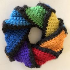 a multicolored knitted circle on a white surface