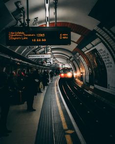 a train is coming down the tracks in a subway station