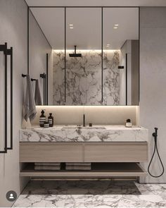 a modern bathroom with marble counter tops and mirrors on the wall, along with two sinks