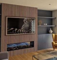 a living room filled with furniture and a zebra painting hanging on the wall above a fire place