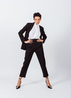 Create a borrowed-from-the-boys ensemble with this pair of black pants from Le Réussi. Crafted from linen blend with white stripes, they start at a high-rise waist and fall into a slim-straight leg. Take inspiration from the FW22-23, letting yours anchor an '80s-inspired outfit.  . Color: Black with White stripes 
. Length: 38.6 inches 
. Care: Dry Clean 
. Composition: 30% Linen, 67% Viscose, 3% Spendex 
. Sizing: 
    • Fits true to size 
    • Designed for a regular fit 
    • Mid-weight, non 80s Inspired Outfits, Black Pinstripe Suit, Striped Linen Pants, Pinstripe Pants, Black Pins, Pinstripe Suit, Boys Bottoms, White Hot, Trouser Pants Women