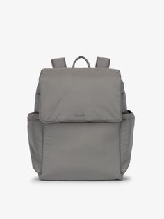 a grey backpack with two straps and an external pocket on the front, sitting against a white background