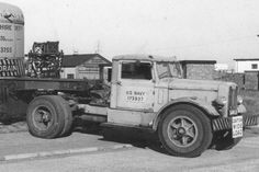 an old truck is parked on the side of the road