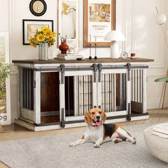 a dog laying on the floor in front of a wooden table with two doors open