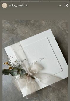 an open white box with a flower on it