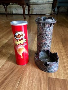 a can of pringles next to an old tower on the floor in a living room