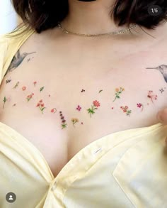 a woman with tattoos on her chest wearing a yellow dress