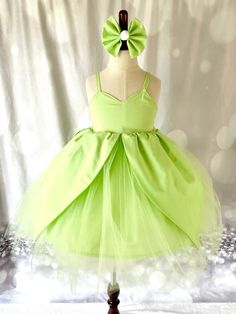 This Tinkerbell Inspired costume is perfect for your little girl. This cute dress is made with green cotton fabric, green tulle. The dress is fully lined and serged for a professional finish.    This dress includes a petticoat for the added puffiness and fullness. (Please note that petticoat is not attached to the dress. The petticoat is removable and can be used for this costume and well as other dresses. You will receive one dress and one petticoat skirt). To Jazz up this really cute fairy cos Bell Costume, Tinkerbell Costume, Tinker Bell Costume, Petticoat Skirt, Green Tulle, Belle Dress, Cute Fairy, Dress Tulle, Toddler Costumes