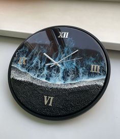 a clock that is on the side of a window sill with water in it