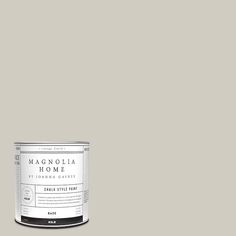 a can of gray paint with the words magnolia home in white on it and an image of