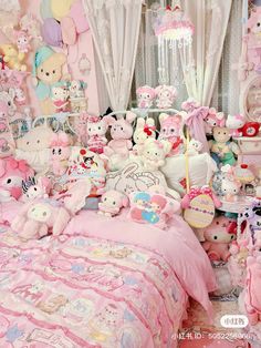 a room filled with lots of stuffed animals next to a bed covered in pink sheets