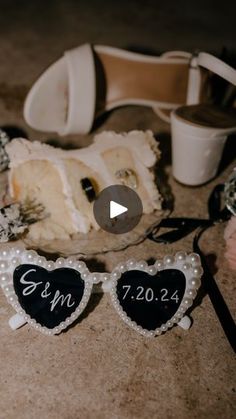 a pair of heart shaped sunglasses sitting on top of a table next to other items