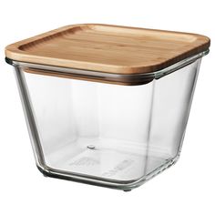 a glass container with a wooden lid