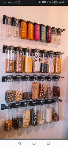 a wall mounted spice rack filled with lots of different types of spices and seasonings