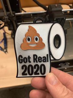 someone holding up a sticker that says, got real 2020