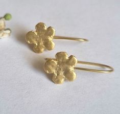 Beautiful gold or sterling silver flower earrings, dainty and minimalist jewelry earrings for girls and women, available in 14k quality gold plating, sterling silver, and solid gold.  These drop earrings are romantic and delicate. The earrings were carved in wax and later cast in metal. They are available in sterling silver, high-quality 14k gold plating, 9k solid yellow gold, and 14k solid yellow gold. These earrings are elegant and lightweight. They will be perfect for a minimalist, delicate l Gold Earrings With Flower Charm As Gift For Her, Gold Earrings With Flower Charm For Her, Gold Flower Charm Earrings As A Gift For Her, Gold Nickel-free Flower Earrings As Gift For Her, Minimalist Gold Flower Shaped Earrings, Dainty Gold-plated Flower Charm Earrings, Gold Plated Dainty Earrings With Flower Charm, Dainty Gold Plated Earrings With Flower Charm, Delicate Gold Flower Earrings In Sterling Silver