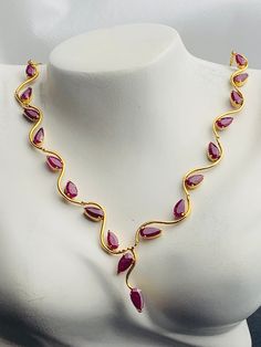 This necklace  will elevate your whole outfit for any special occasions.  Natural Burmese Ruby Necklace in 18K  Yellow  Gold.  Weight of Ruby  18 pcs  7.5 ct Total weight of necklace  9.61 gm Gold net weight 8.11 gm Length and Width of each Stone  7.56 X 3.88 mm. 7.75 x 3.58 mm. 6.45 x 3.39 mm 6.44 x 3.82 mm (average) Length of necklace - 53.5 cm Length and width of Ruby   175.5 x 21.22 mm Gemstone  -   Natural Burmese Ruby Treatments -  Heated Colour  -   Red Transparency  - Transparent Clarity Formal Bridal Necklace In Yellow Gold With Gemstone, Formal Yellow Gold Bridal Necklace With Gemstone, Formal Ruby Necklace With Hallmark, Formal Ruby Gemstone Necklaces, Formal Ruby Gemstone Necklace, Elegant Ruby Necklace For Formal Occasions, Pagadam Jewellery, Grand Jewellery, Trendy Silver Jewelry