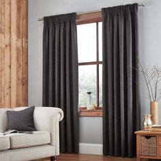 a living room with gray walls and curtains