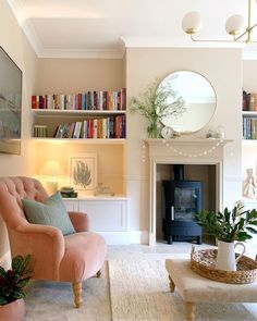 a living room filled with furniture and a fire place in front of a book shelf