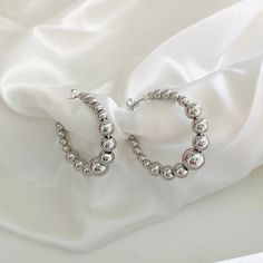 For lovers of silver jewelry, we present our classic ball earrings that will always give you a modern and attractive look. Hoop Width: 33mm Bead Width Range: 3.8mm - 7.8mm FAST & FREE SHIPPING. Our handmade products are rated very highly by our customers. We work hard with our Quality Control department to ensure the quality you deserve. -New! -Excellent quality. Looks even better in person. -This is a product for women -Check out my other jewelry listings in my store! -Message me with any quest Silver Ball Hoop Earrings, Silver Beaded Hoop Earrings As Gift, Gift Hoop Earrings With Silver Beads, Silver Earrings With Polished Beads For Gift, Hypoallergenic Sterling Silver Hoop Earrings With Round Beads, Hoop Earrings With Silver Beads, Silver Hoop Earrings With Silver Beads, Silver Earrings With Polished Beads, Hypoallergenic Silver Hoop Earrings