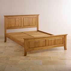 a wooden bed frame sitting on top of a tiled floor