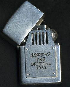 a zippo lighter with the original 1932 logo on it's side and its cover opened