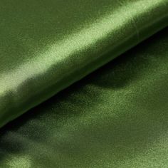 a close up shot of a green satin fabric