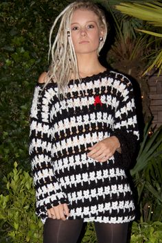 a woman with blonde hair wearing black and white sweater