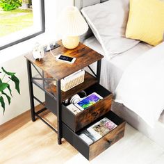 a bed room with a neatly made bed and a night stand next to the bed