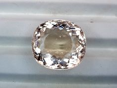 an oval shaped diamond on a white surface