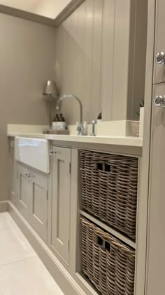 a kitchen with two wicker baskets on the cabinets