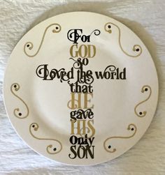 a white plate with a cross on it that says for god so loved the world that he gave his only son