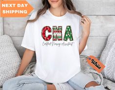 Christmas CNA Comfort Colors® Shirt, Cna Nurse Christmas Shirt, Xmas Cna Gift, Certified Nursing Assistant, Nurse Christmas Matching Shirt HOW TO PLACE AN ORDER: 1. Choose the shirt color from the available options in the drop-down menu. (Please note that actual colors may slightly vary due to monitor differences.) 2. Click "Add to Cart". You can always add more shirts to your order. 2. Proceed to checkout to complete your purchase. 4. During checkout, feel free to add a note to the seller for any specific requests or customizations you may have. * We are fully equipped to handle personalization and custom design requests of all kinds. * Printed with Premium Quality in the USA. * This design will be crafted using DTG printing technology (Please refer to all photos). * Please be aware that Cna Nurse, Certified Nursing Assistant, Nurse Christmas, Nursing Assistant, Matching Shirts, Christmas Shirts, Favorite Things Gift, Comfort Colors, Colorful Shirts