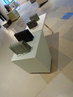 two chairs sitting on top of a white table in a room with tile flooring