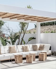 a white couch sitting under a pergolated roof