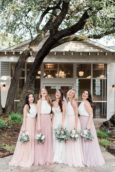 the bridesmaids are posing for a photo in front of their wedding venue at this rustic