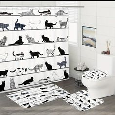 a bathroom with black and white cats on the shower curtain, rugs and toilet