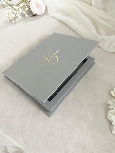 the wedding album is sitting next to flowers