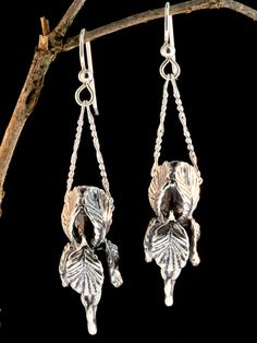 "Our Iris is in full bloom and it makes a lovely pair of earrings. This beautiful Iris flaunts curvaceous frilled petals and the stem is detailed with unfolding leaves. It is cast in sterling silver and is 1 3/8\" long and 1/2\" across. A chain slips through side openings between the petals and hangs from the ear wire. Bringing this design to fruition was fraught with technical challenges but I am thrilled with how it turned out. Creating an intricate design with an open center is difficult so t Nature-inspired Drop Flower Earrings For Pierced Ears, Nature-inspired Sterling Silver Flower Earrings, Nature-inspired Dangle Earrings With Flower Charm, Nature-inspired Dangle Flower Earrings, Bohemian Dangle Earrings With Birth Flower, Iris Earrings, Iris Jewelry, Bohemian Jewels, Victorian Earrings