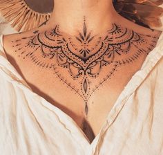 a woman's back neck with an intricate design on the top and bottom part