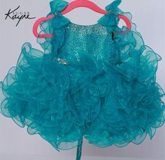 The Sugar Kayne C229 Cupcake Pageant Dress features bowed shoulders atop a hot stone bodice and a short, ruffled skirt, making it an ideal choice for toddlers and girls. Colors: Blue, Pink, Orange, Yellow, White Sizes: 0M, 12M, 18M, 24M, 2T, 3T, 4T, 5T, 6M, 6T Cupcake Pageant Dress, Organza Gown, Johnathan Kayne, Organza Gowns, Organza Skirt, Dress Bow, Pink Orange Yellow, Girls Pageant Dresses, Corset Back