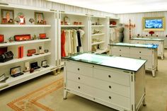 a room filled with lots of white furniture and shelves full of different types of items