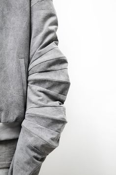 a person wearing a gray hoodie and pants