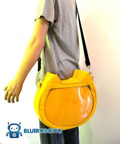 a person with a yellow handbag on their shoulder and the bottom half of his body