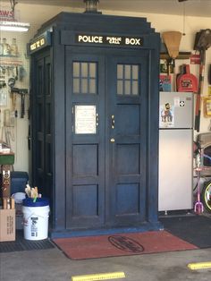 a blue police box sitting inside of a garage